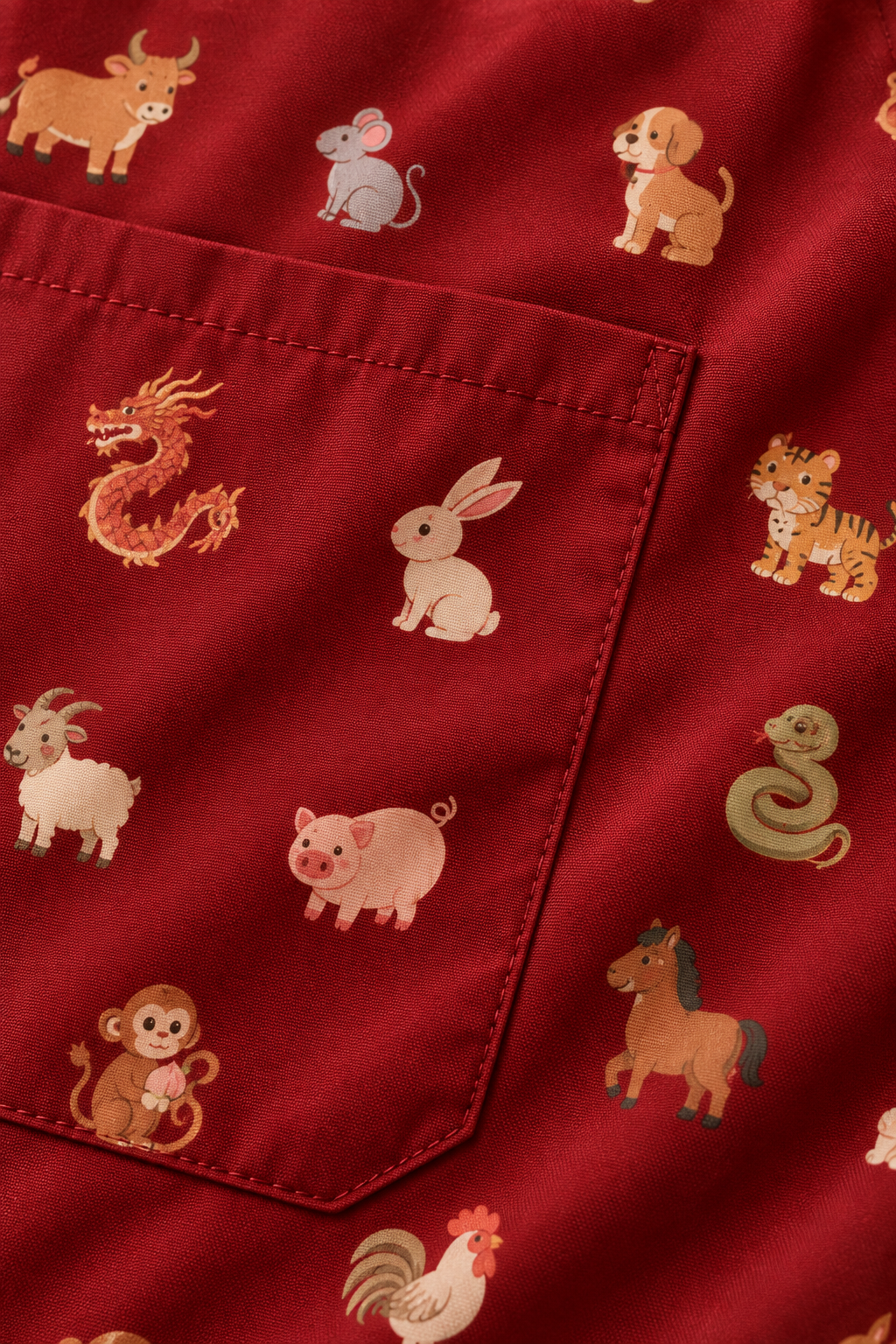 Design concept: close-up of maroon zodiac print fabric and scrub pocket stitching.