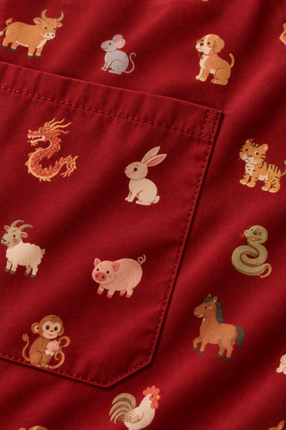 Design concept: close-up of maroon zodiac print fabric and scrub pocket stitching.