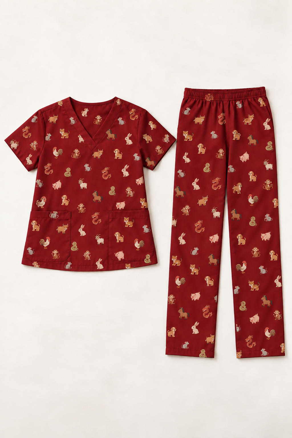 Design concept: maroon full scrub set with a dense, irregular scattering of cute Chinese zodiac animals across the top and pants.